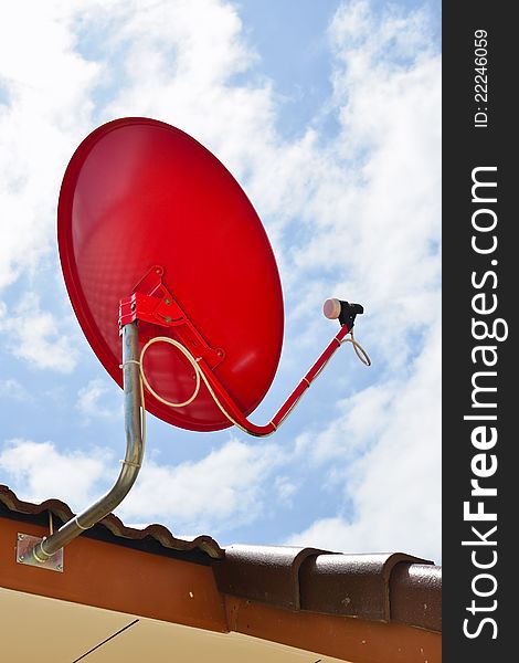 Red satellite dish installing on the roof