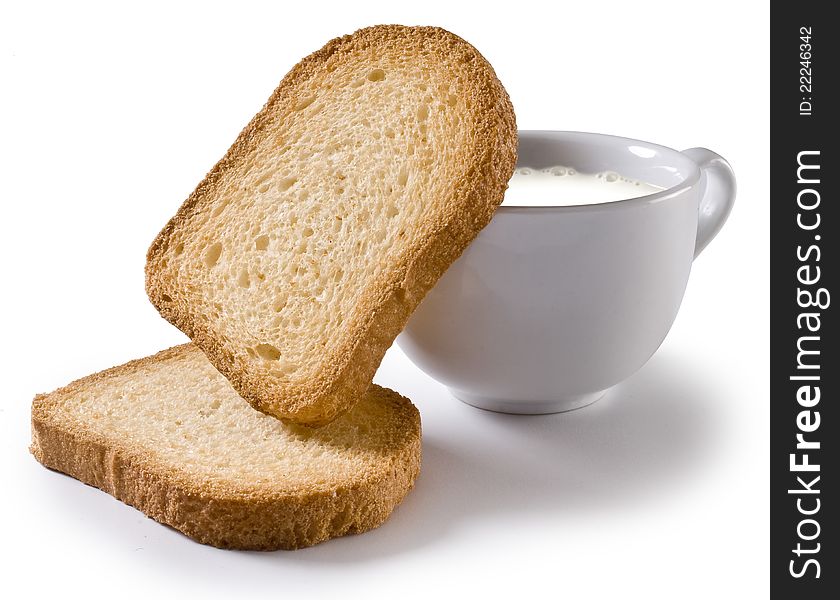 Toasted slices of bread and a cup of milk. Toasted slices of bread and a cup of milk