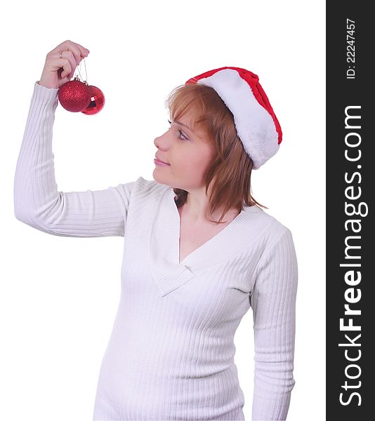 Girl with christmas hat and christmas balls over white. Girl with christmas hat and christmas balls over white