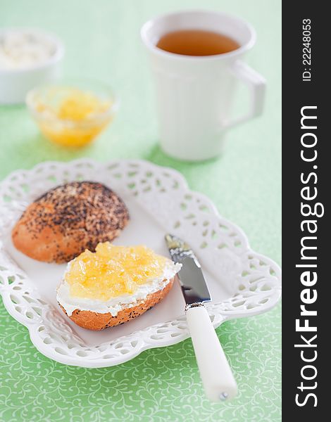 Bread with lemon jam and cream cheese on plate, selective focus