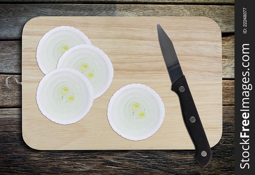 Sliced red onion and knife on chopping board. Sliced red onion and knife on chopping board