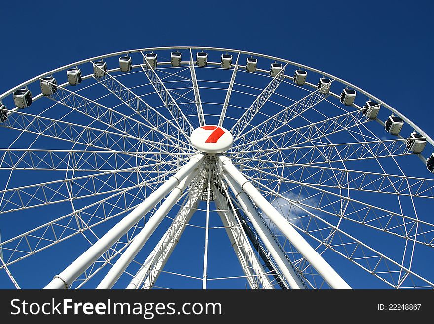 White Ferris Wheel Agains A Clear Blue Sky