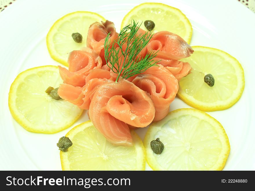 Smoked salmon slice with lemon slice decorate with dill