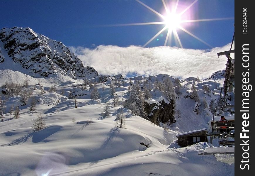 On the ski lift in the winter Alps