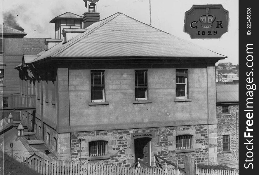 Photographer: unidentified

Location: Brisbane

Description: The Commissariat Store in Brisbane is Queensland’s second-oldest building, surpassed only by the Old Observatory in Wickham Terrace. Constructed between May 1828 and December 1829 during the regime of Captain Patrick Logan, Commandant of the Moreton Bay penal settlement, the Commissariat Store is of Georgian design with freestone walls. In 1886 a single-storey brick building was added to the south-east wing, with a second storey being completed in 1900, though the entire wing was later demolished. In 1912-1913 a third storey was added to the entire existing structure.

When first completed, the Commissariat Store was contiguous to a wharf and crane for the convenient unloading of docked vessels. After fulfilling this role the building was used to house immigrants, as offices for the Queensland Law Reform Commission and as a repository for Queensland State Archives. Fittingly, the Commissariat Store now serves as the headquarters of the Royal Historical Society of Queensland. &#x28;Information taken from: Queensland State Archives, retrieved on 30 November 2012 at  http://www.archives.qld.gov.au/Researchers/Exhibitions/Top150/051-075/Pages/051.aspx&#x29; 

View this page at the State Library of Queensland  hdl.handle.net/10462/deriv/93280 
Information about State Library of Queensland’s collection: www.slq.qld.gov.au/resources/picture-queensland. Photographer: unidentified

Location: Brisbane

Description: The Commissariat Store in Brisbane is Queensland’s second-oldest building, surpassed only by the Old Observatory in Wickham Terrace. Constructed between May 1828 and December 1829 during the regime of Captain Patrick Logan, Commandant of the Moreton Bay penal settlement, the Commissariat Store is of Georgian design with freestone walls. In 1886 a single-storey brick building was added to the south-east wing, with a second storey being completed in 1900, though the entire wing was later demolished. In 1912-1913 a third storey was added to the entire existing structure.

When first completed, the Commissariat Store was contiguous to a wharf and crane for the convenient unloading of docked vessels. After fulfilling this role the building was used to house immigrants, as offices for the Queensland Law Reform Commission and as a repository for Queensland State Archives. Fittingly, the Commissariat Store now serves as the headquarters of the Royal Historical Society of Queensland. &#x28;Information taken from: Queensland State Archives, retrieved on 30 November 2012 at  http://www.archives.qld.gov.au/Researchers/Exhibitions/Top150/051-075/Pages/051.aspx&#x29; 

View this page at the State Library of Queensland  hdl.handle.net/10462/deriv/93280 
Information about State Library of Queensland’s collection: www.slq.qld.gov.au/resources/picture-queensland