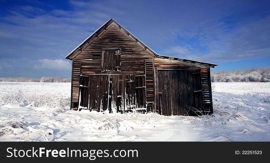 Old barn in the snow after a storm. Old barn in the snow after a storm