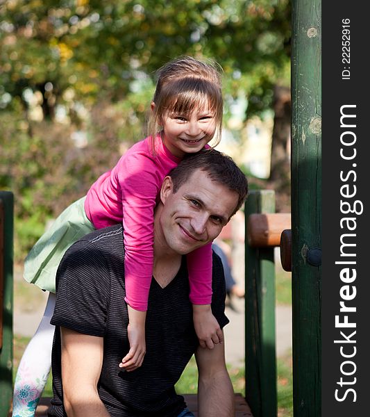 Little girl with her father is spending time at the park. Little girl with her father is spending time at the park.