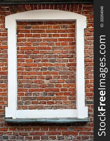 White window frame filled with bricks. White window frame filled with bricks