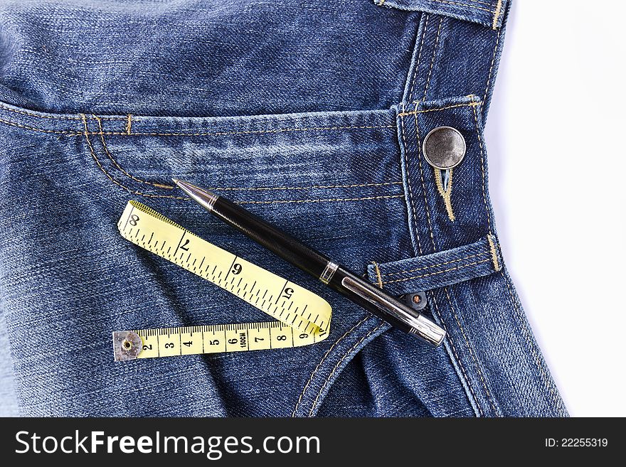 Pen and Measuring tape on front blue jeans