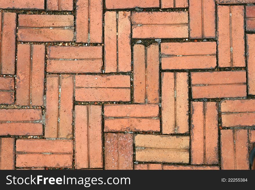 Pattern of Crossing Red Stone pavement, background, Closeup