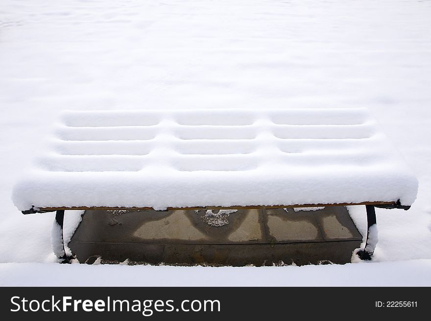 The bench covered with snow. The bench covered with snow