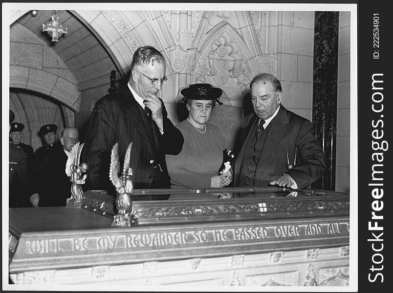 John Curtin and Mrs Curtin with Canadian Prime Minister Mackenzie King, examining Book of Remembrance in Memorial Chamber, Peace T