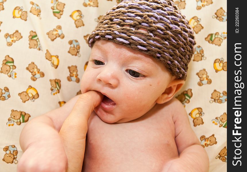 Portrait of a baby girl with teddy bear fabric background.