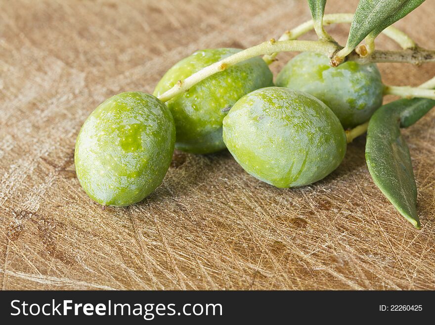 Close up of branch Olives on a wooden table