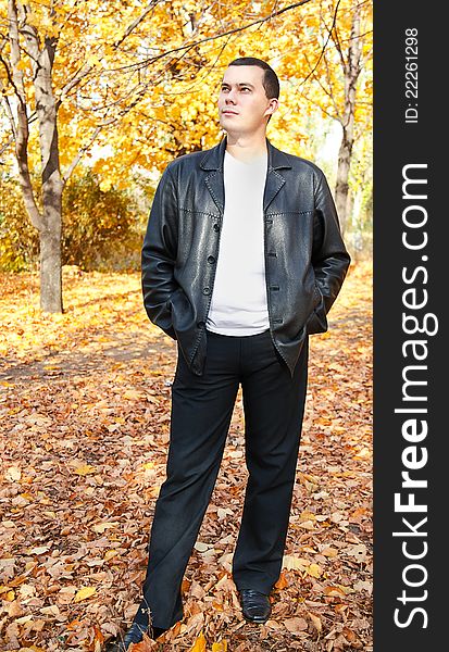 Outdoors portrait of young man in autumn park. Outdoors portrait of young man in autumn park