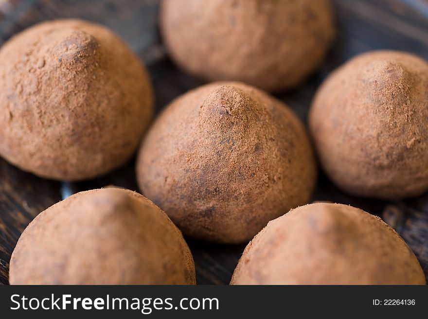 Chocolate truffles on a wooden background. Chocolate truffles on a wooden background