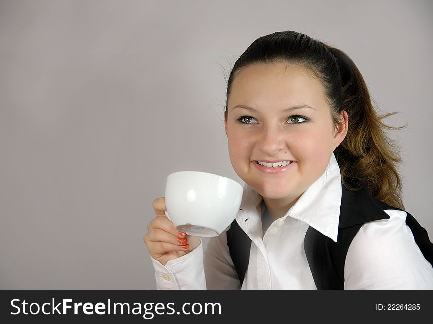 Young woman office worker on break drinking coffee operator. Young woman office worker on break drinking coffee operator