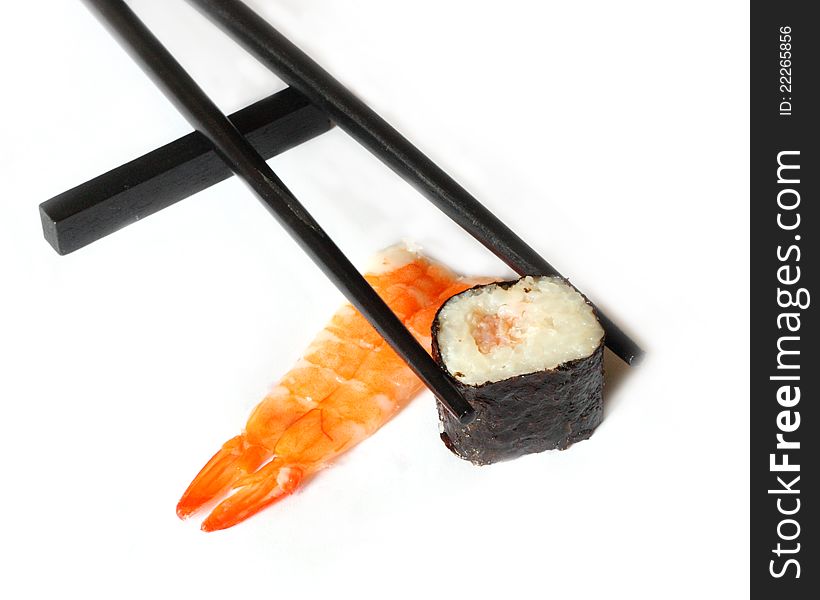 Elicious sushi and chopsticks isolated on white