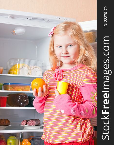 Girl with food on background fridge. Girl with food on background fridge