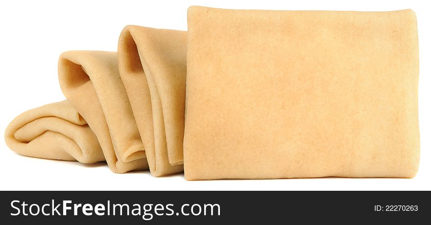 Four stuffed pancakes folded in envelope on a white background