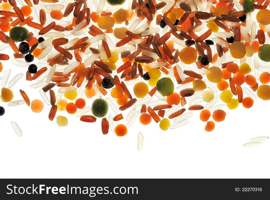 White and red rice, lentils and split peas on a white background (backlit)