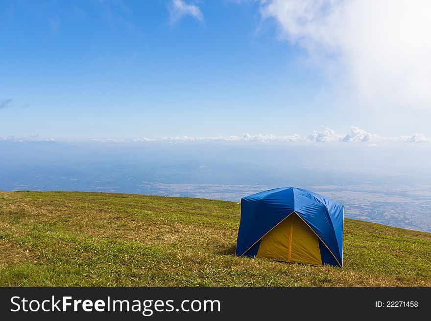 Tent on a grass under white clouds and blue sky. Tent on a grass under white clouds and blue sky