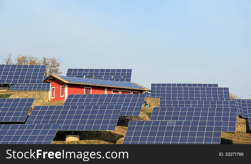 A small hill covered by solar panels. A small hill covered by solar panels