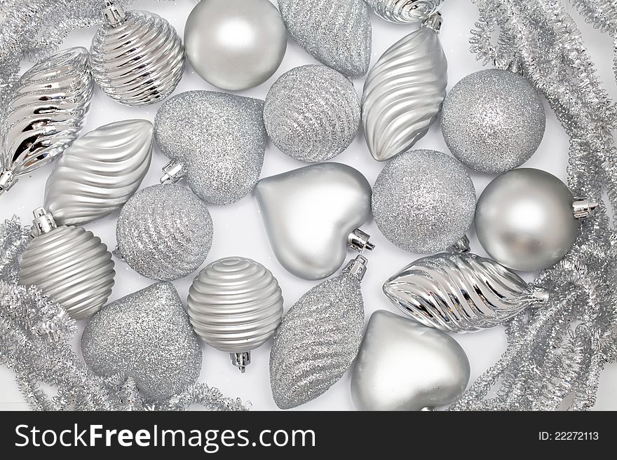 Many silver baubles on white background. Many silver baubles on white background