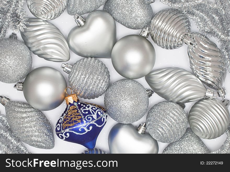 Many silver baubles and one blue on white background. Many silver baubles and one blue on white background