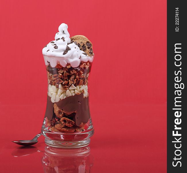 Chocolate nut dessert in a glass with a reflection