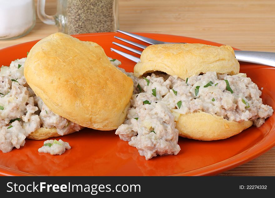 Breakfast of two sausage biscuits on a plate
