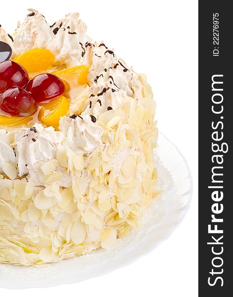 Close-up of a creamy cake with fruits and almonds