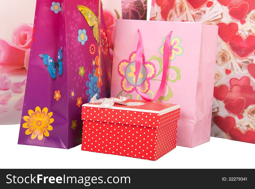 Decorative bags with gifts isolated on white