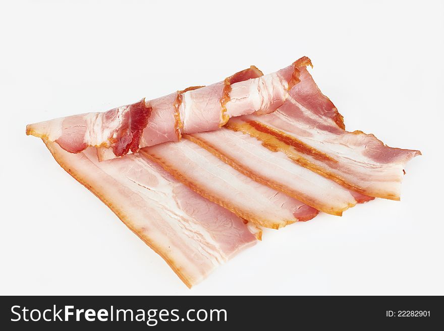 Tasty sliced pork bacon on white background