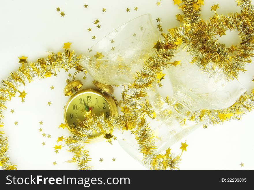 Vintage clock showing almost midnight with champagne glasses, golden confetti stars and decoration. Vintage clock showing almost midnight with champagne glasses, golden confetti stars and decoration.