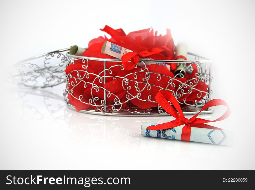 Shining metal box with money and rose petals  on white. Shining metal box with money and rose petals  on white