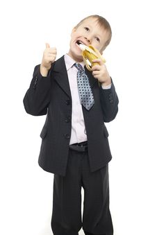 Beautiful Child In Costume Eating A Banana Royalty Free Stock Images