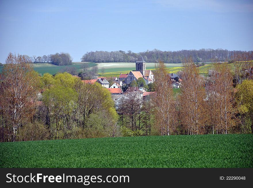 A small french village nestling amongst the fields and trees of this agricultural landscape. A small french village nestling amongst the fields and trees of this agricultural landscape