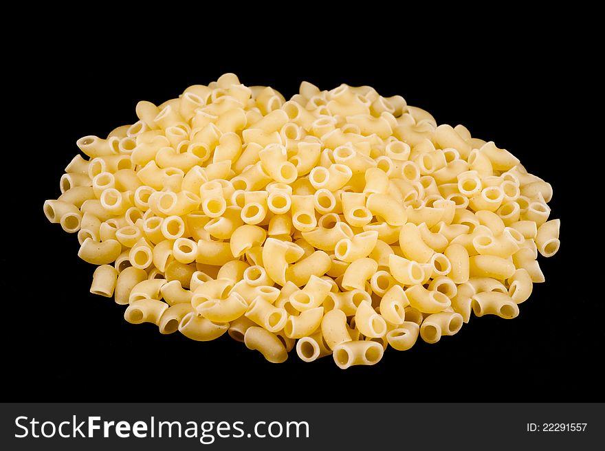 Uncooked small pasta horns with black background