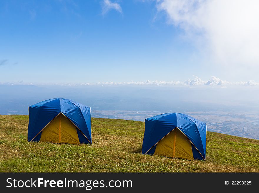 Two Tent on a grass under white clouds and blue sky. Two Tent on a grass under white clouds and blue sky