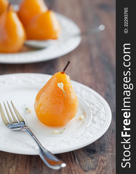 Poached pears with saffron and jasmine syrup, selective focus
