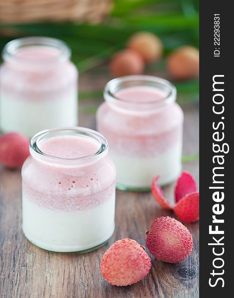 Homemade yogurt and fresh lychee mousse in glass jars, selective focus. Homemade yogurt and fresh lychee mousse in glass jars, selective focus