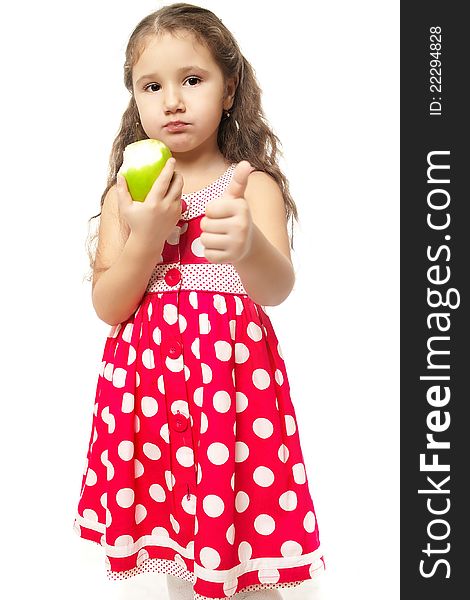 Little Girl In Pink Clothes Eats Green Apple