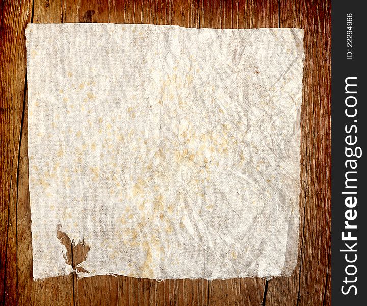 Crumpled paper on old wooden background