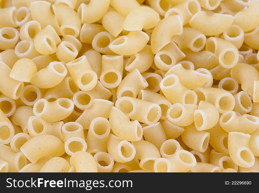 Background of uncooked small pasta horns