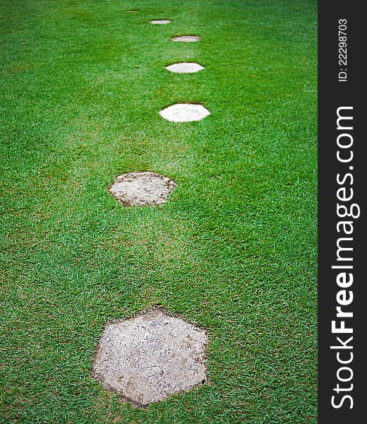 Stepping stones on a field of green grass. Stepping stones on a field of green grass.