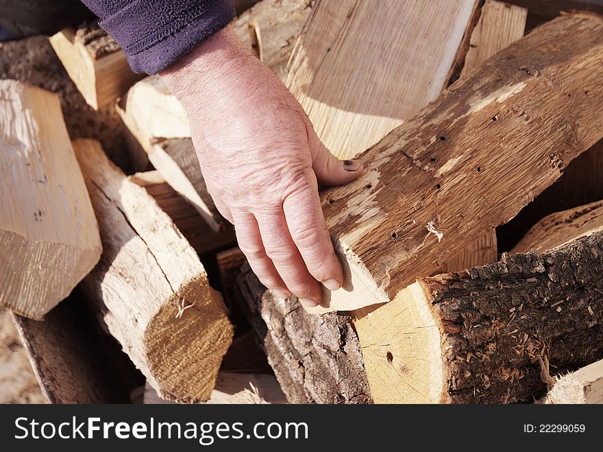 Winter time and snapshot over the hand of a worker over some wood pieces. Winter time and snapshot over the hand of a worker over some wood pieces