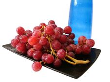Dish With Grapes And Bottle Royalty Free Stock Photo