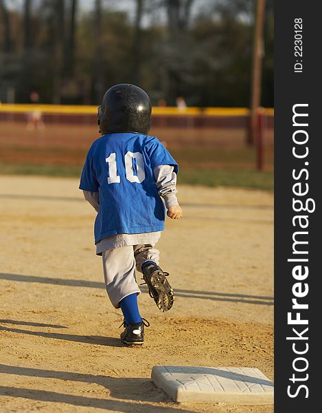 Young ball player in blue baseball uniform. Young ball player in blue baseball uniform