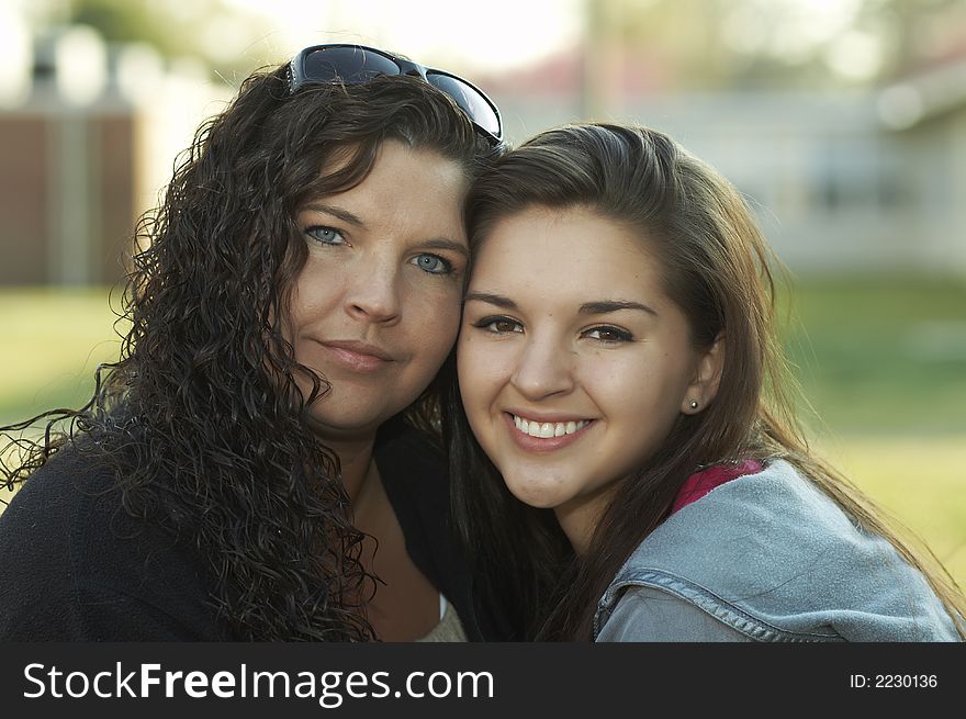 Mom and daughter smiling at camera. Mom and daughter smiling at camera